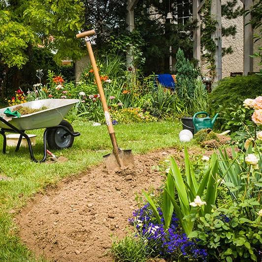 Freshly dug flower bed ready for planting in a Chichester garden